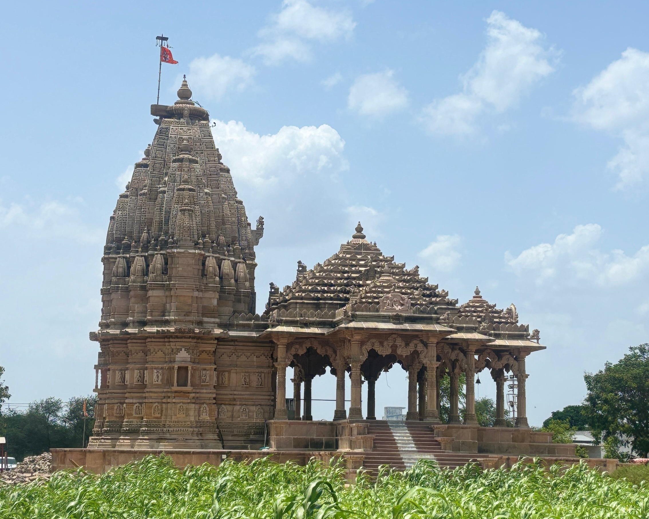 Person meditating near temple stone work